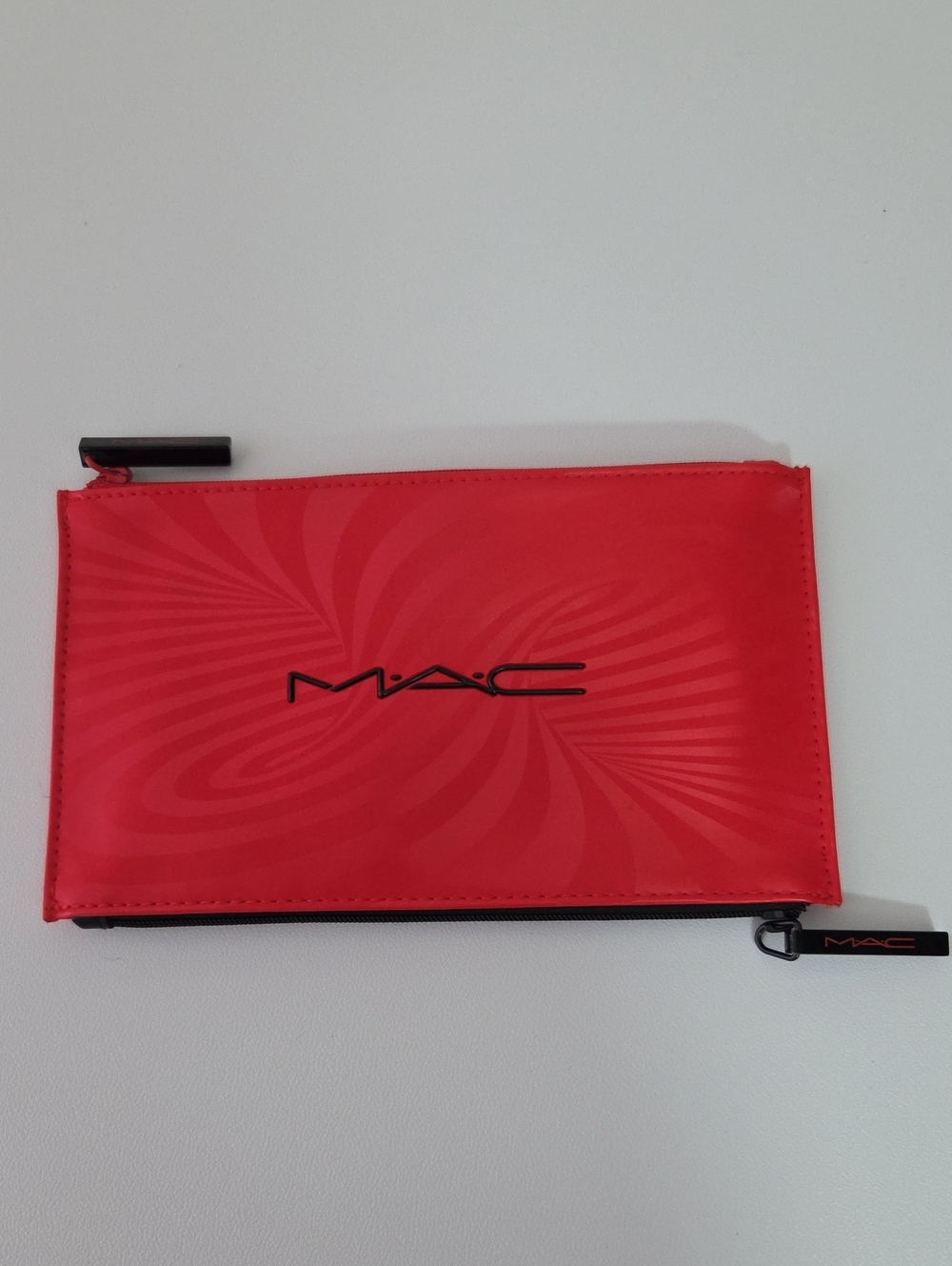 MAC Cosmetics red zip cosmetic sleeve with swirl pattern